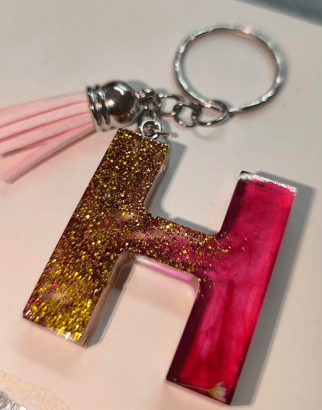 Porte clés initiale "H" doré rose fumé 