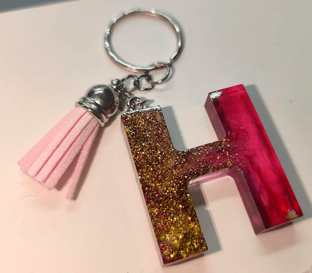 Porte clés initiale "H" doré rose fumé 